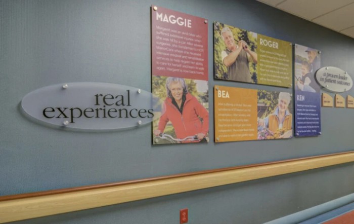 Hospital hallway with posters showcasing patient testimonials.