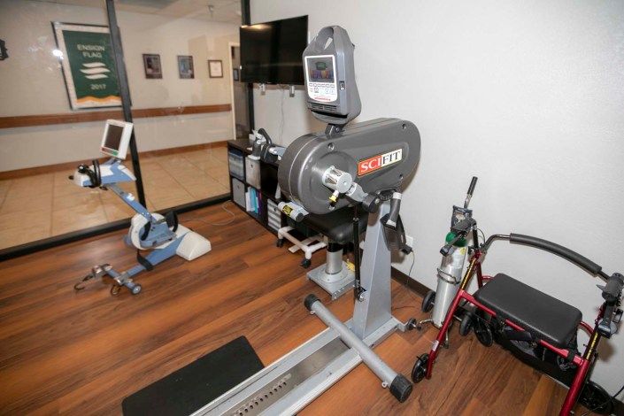 A physical therapy room with various exercise equipment for rehabilitation and fitness activities.