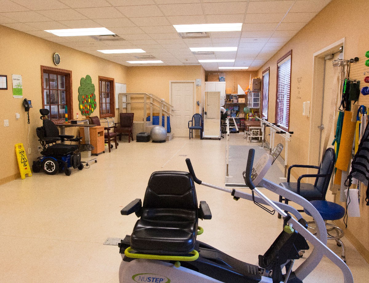 A rehabilitation room equipped with various exercise machines and therapy equipment.
