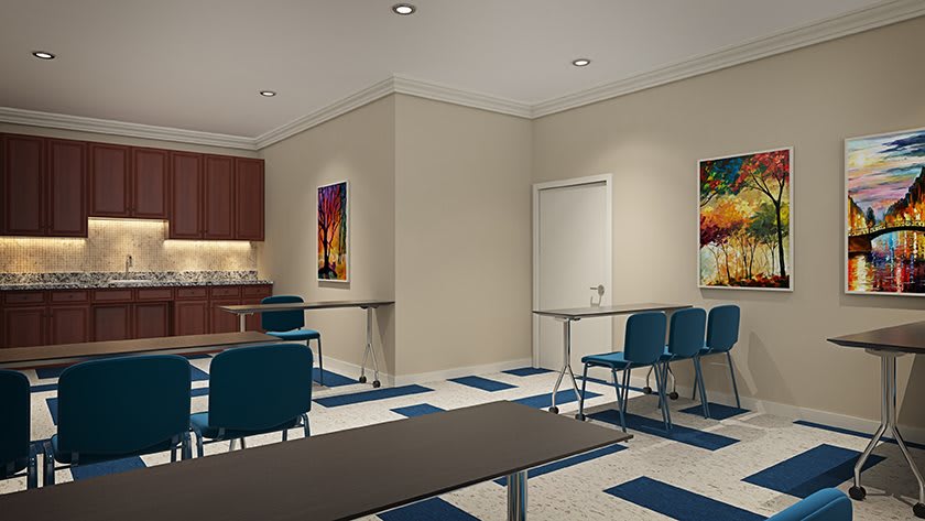 A modern classroom interior with tables, chairs, and colorful artwork on the walls.