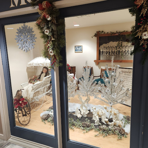 A beautifully decorated storefront window featuring a frosty theme and holiday elements.