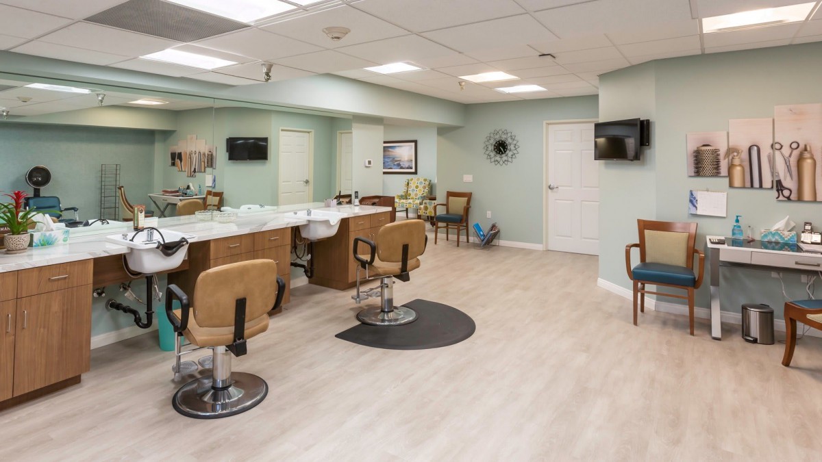A modern salon interior with styling chairs and mirrors.