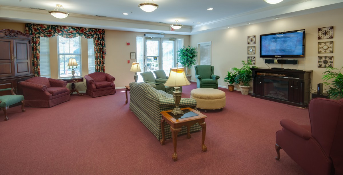 A cozy living room with comfortable seating and warm lighting.