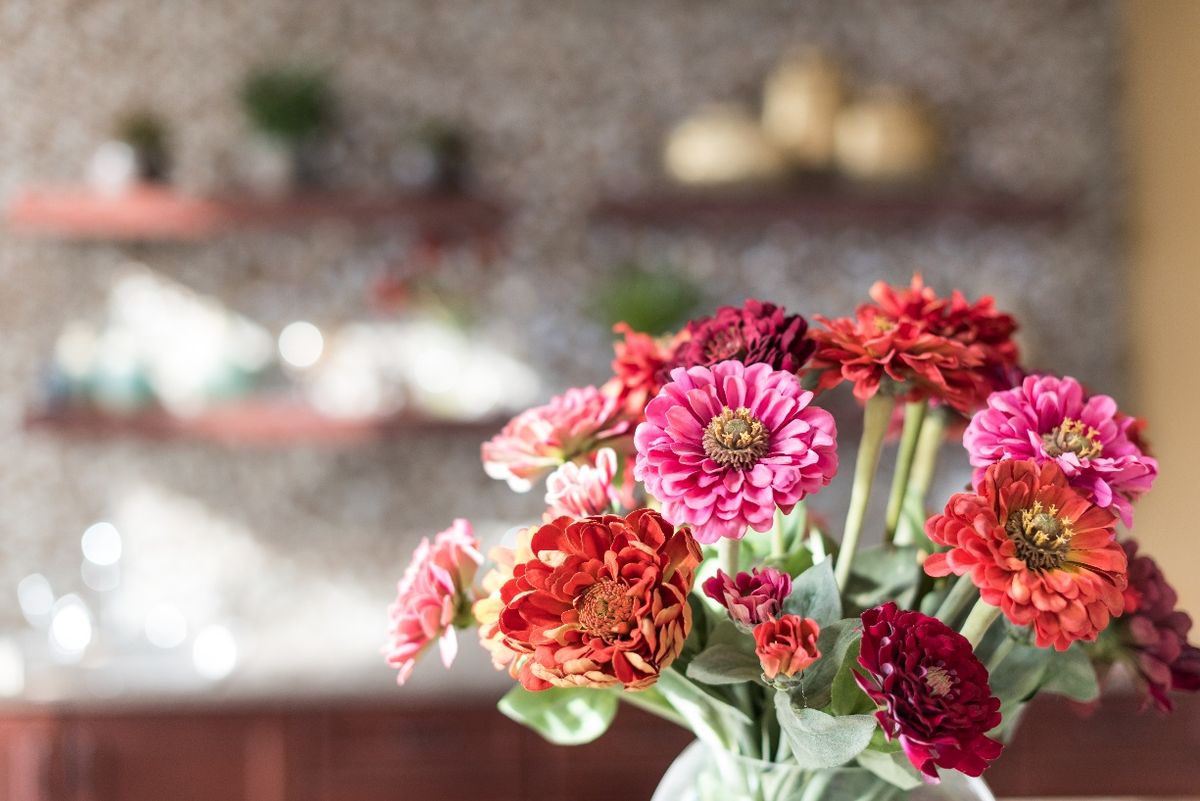 A vibrant bouquet of zinnias adds a splash of color to the room.