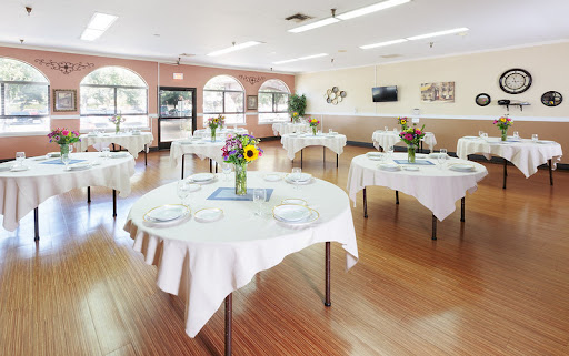 A beautifully arranged dining area with elegant tables set for a gathering.