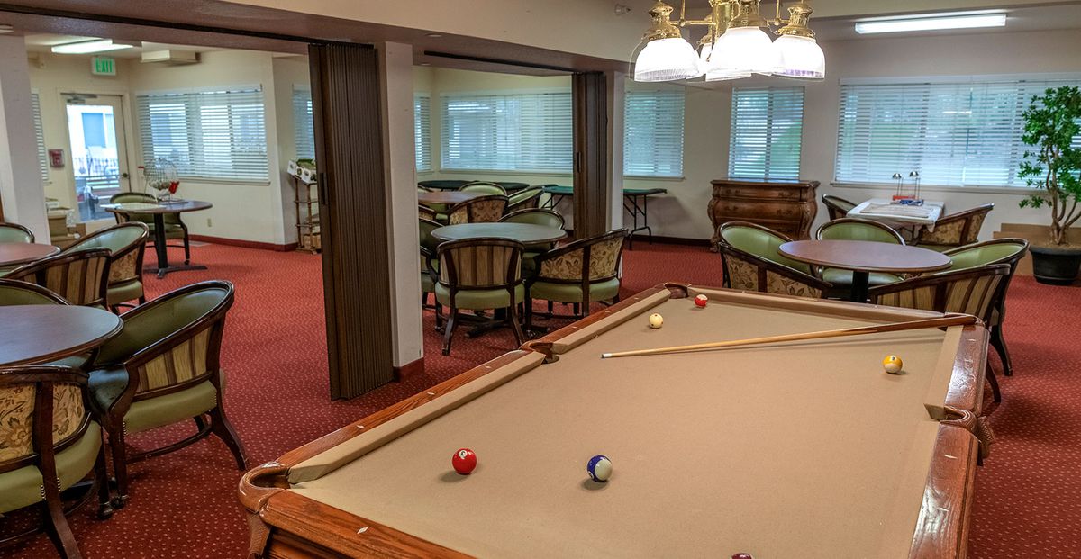 A cozy game room featuring a pool table and seating area.