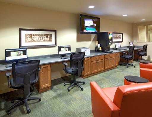 A modern office workspace featuring multiple computer stations and comfortable seating.