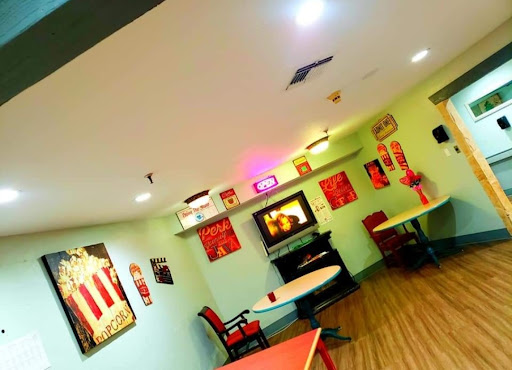 A cozy and vibrant caf interior featuring artistic decorations and comfortable seating.