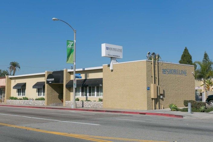 A commercial building with a bank sign on a sunny day.