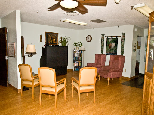 A cozy living room setup featuring comfortable seating and a TV.