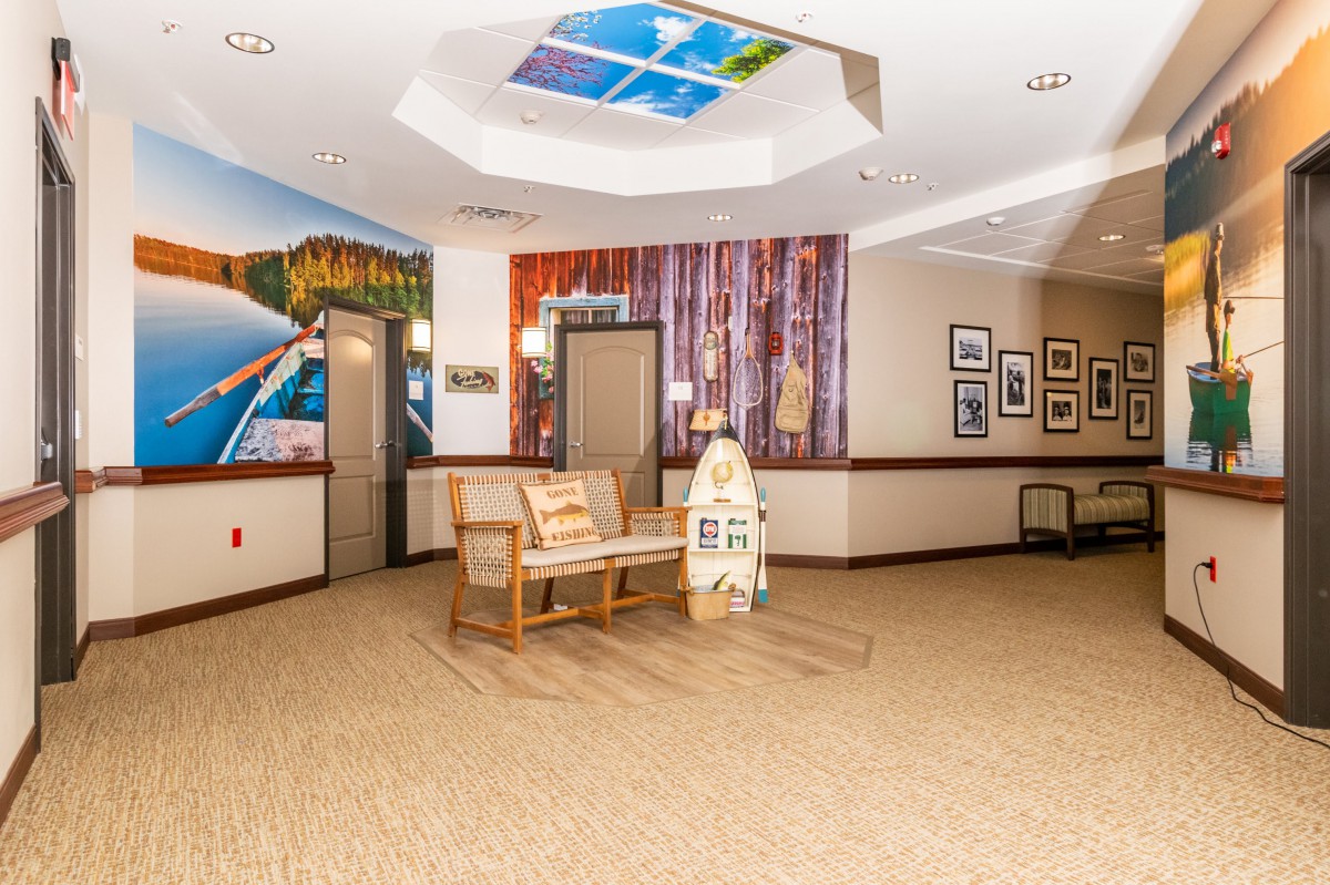 A bright and welcoming lobby area with seating and colorful wall art.