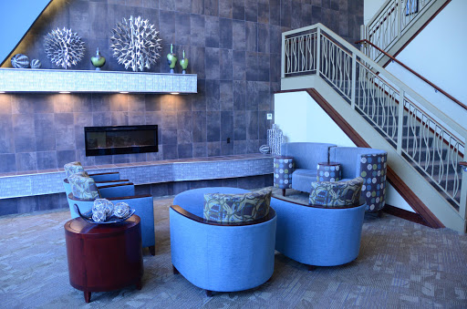 A stylish and modern living room featuring a cozy seating arrangement, a fireplace, and elegant decor.