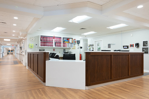 A modern office reception area featuring wooden counters and a clean design.