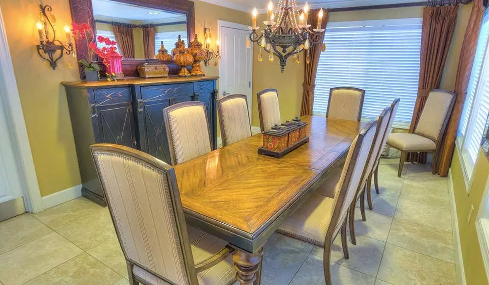 Elegant dining room with a wooden table and chandelier.