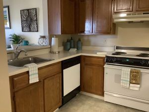 A cozy kitchen with wooden cabinets and modern appliances.