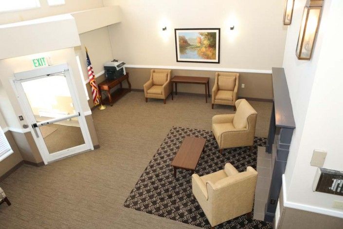 A spacious lobby area with comfortable seating and a decorative rug.