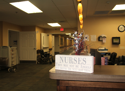 A welcoming view of a healthcare facility featuring a decorative sign for nurses.