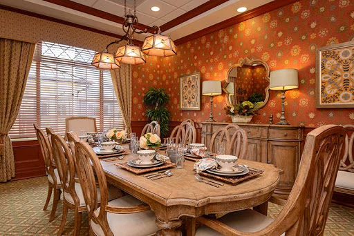 A beautifully designed dining room featuring elegant wooden furniture and a warm, inviting atmosphere.
