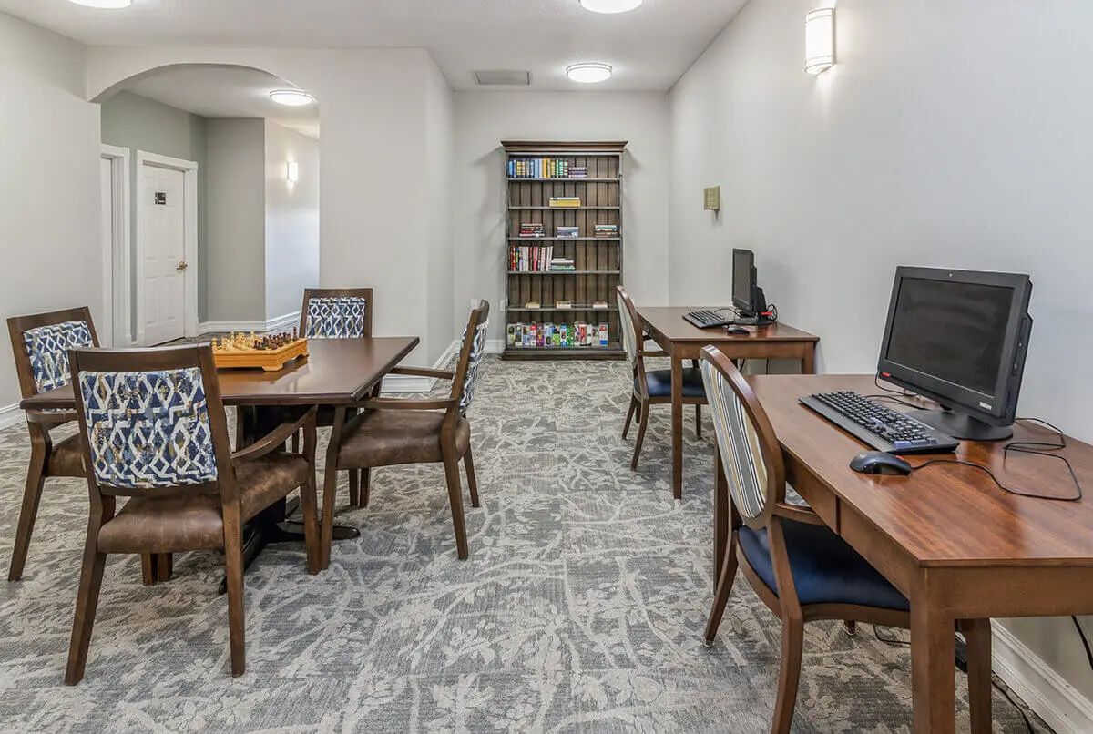 A quiet office space with computers and a bookshelf.