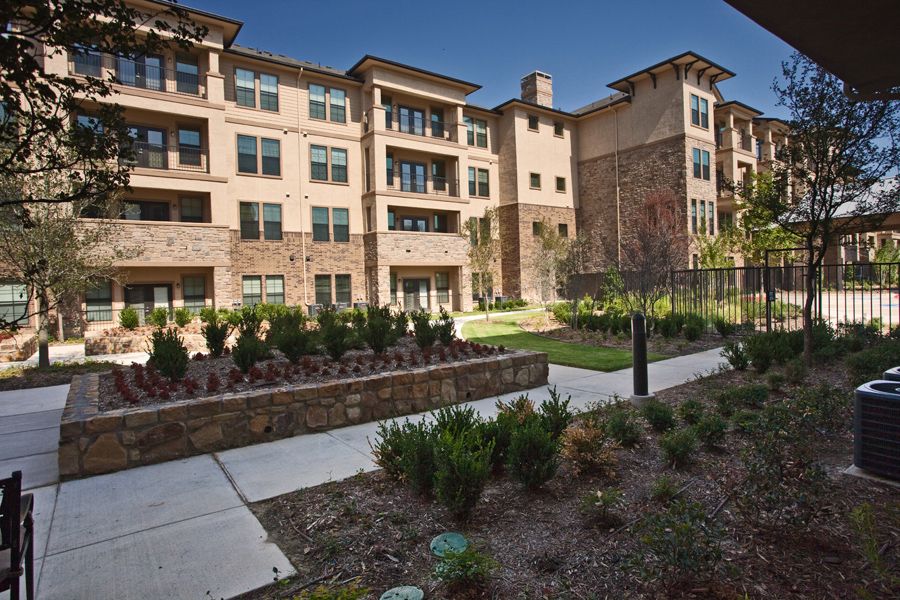A modern residential apartment building with landscaped surroundings.