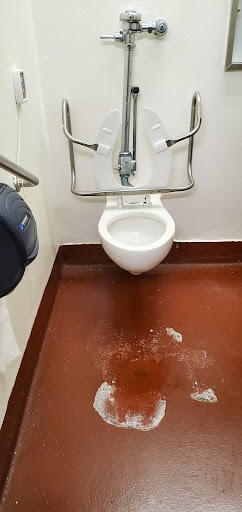 A view of a public restroom toilet area, showcasing the cleanliness and accessibility features.