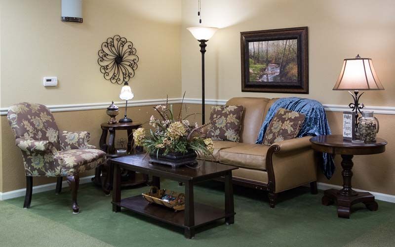 A cozy living room with a sofa, coffee table, and decorative items.