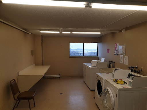 A clean and functional laundry room featuring washing and drying appliances with ample space.