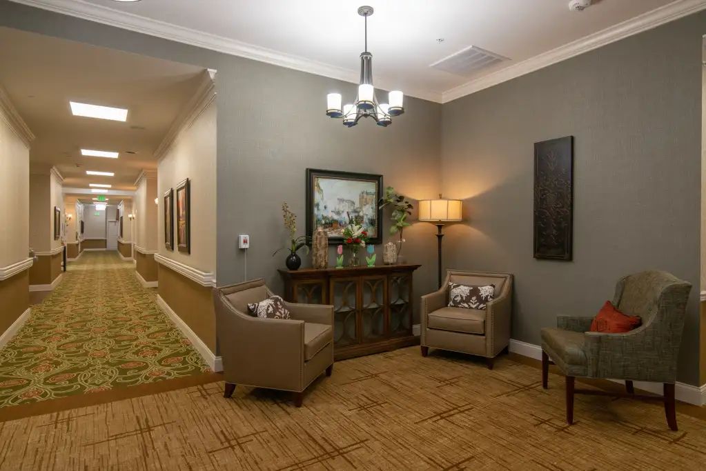 A cozy seating area in a warmly decorated hallway.