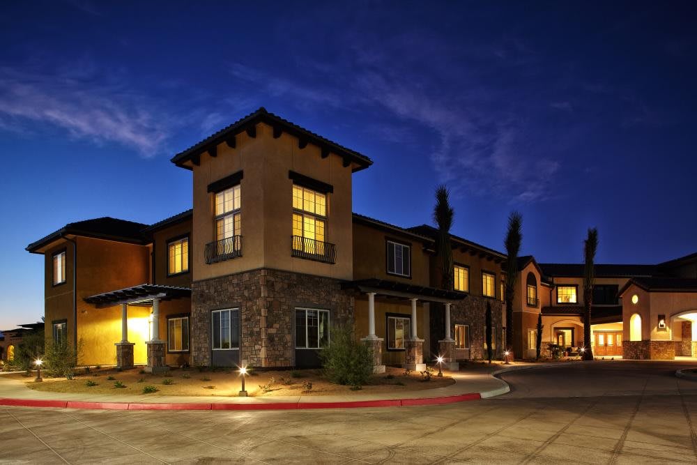 A well-lit residential building at night.