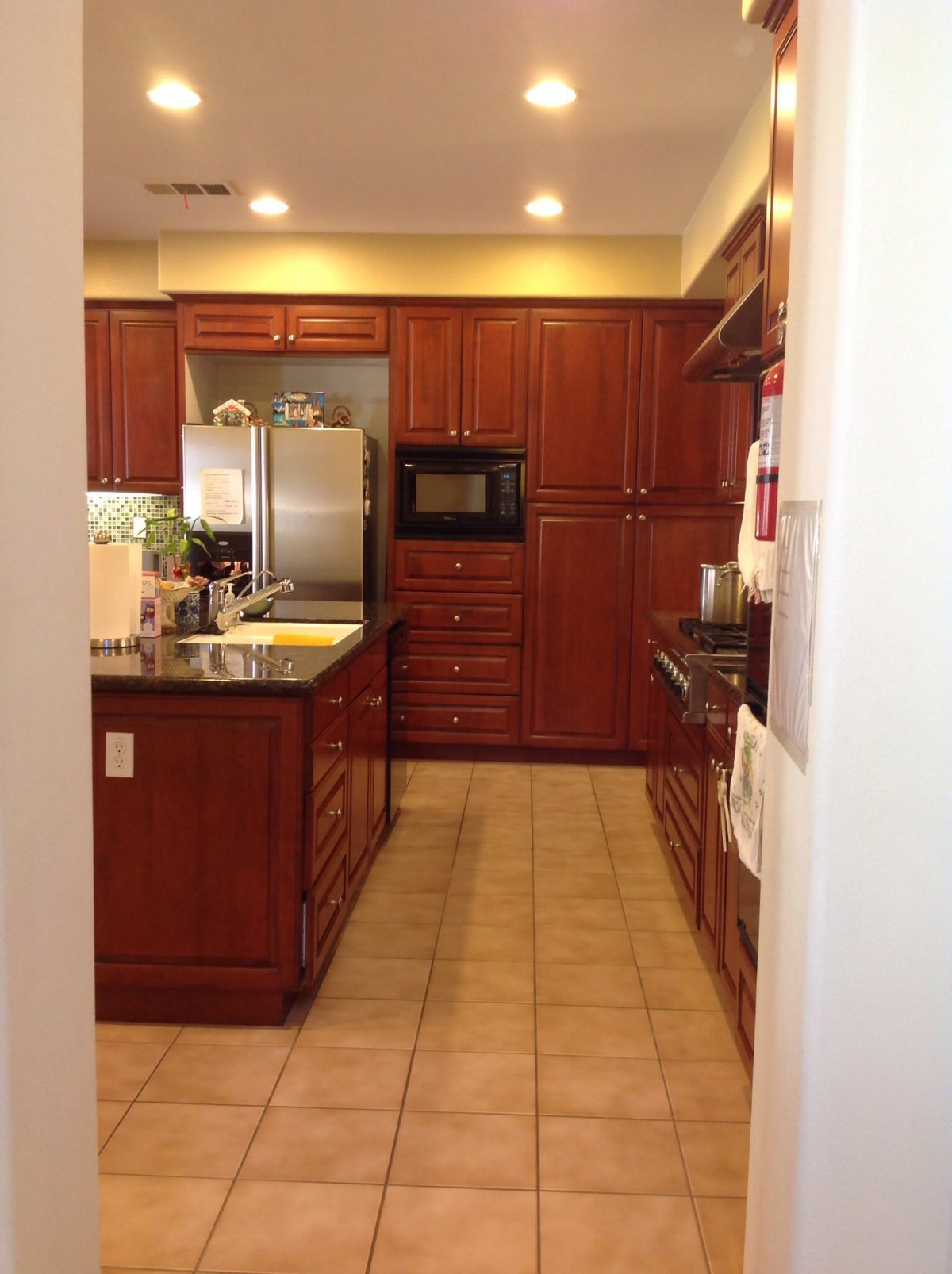 A modern kitchen with wooden cabinets and stainless steel appliances.