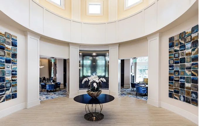 Luxurious hotel lobby with elegant design and central display table.