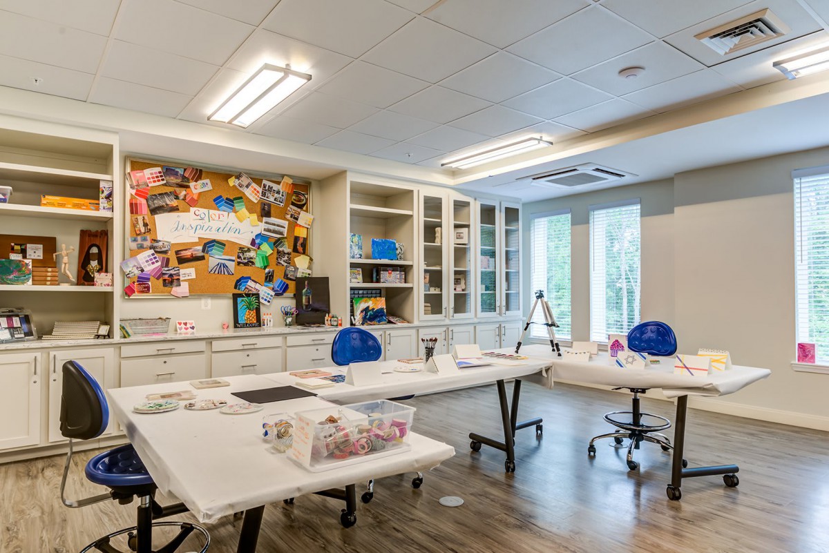 A bright and organized art studio with tables and supplies ready for creativity.