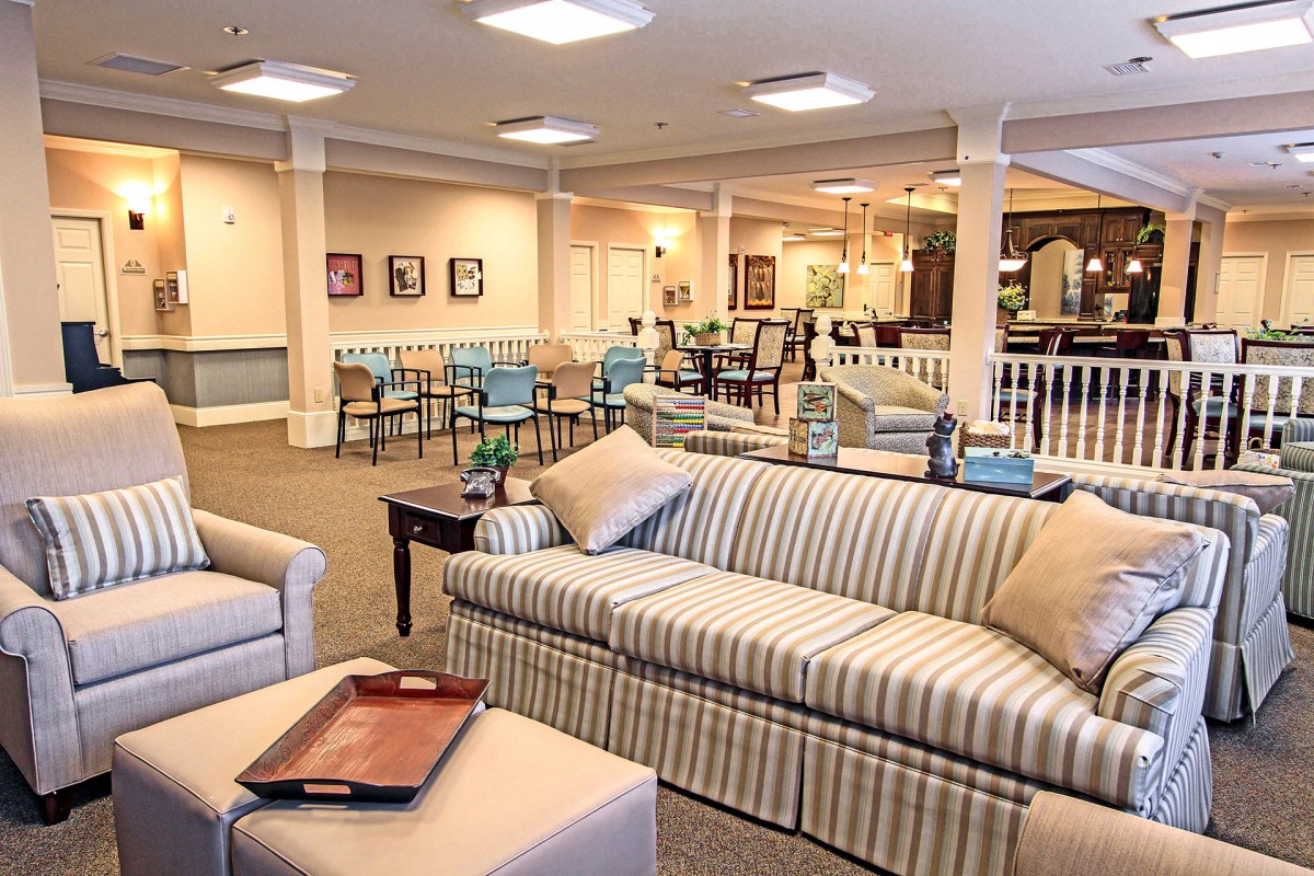 A cozy living room with striped sofas and elegant interior design.