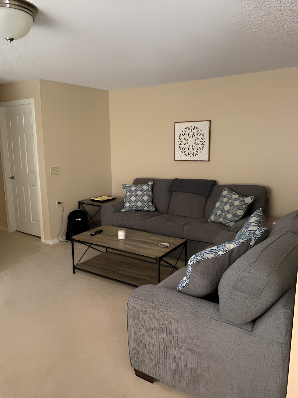A cozy living room with a gray sofa set, coffee table, and decorative wall art.