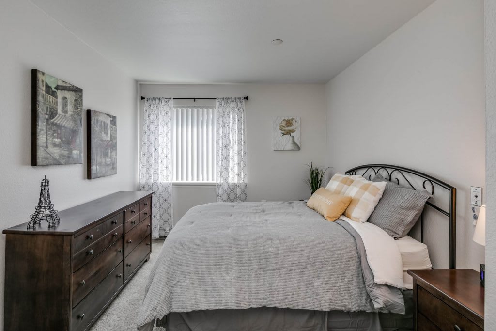 A modern bedroom with a comfortable bed, stylish furniture, and light decor.