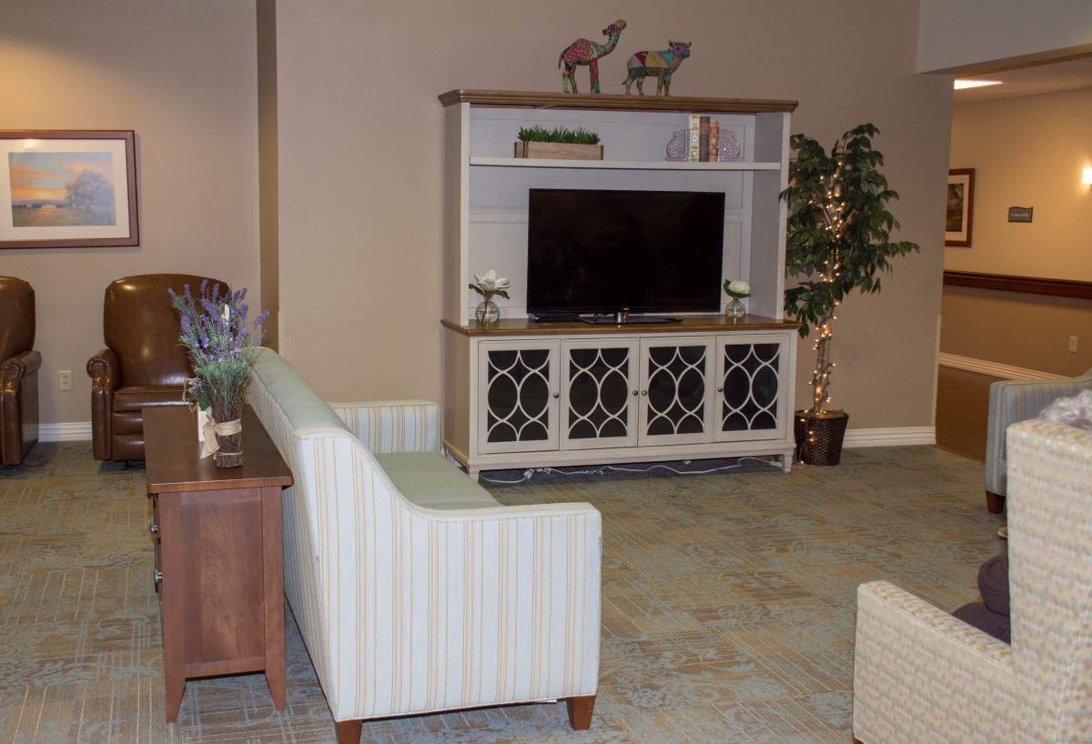 A cozy living room setup with a television and modern furniture.