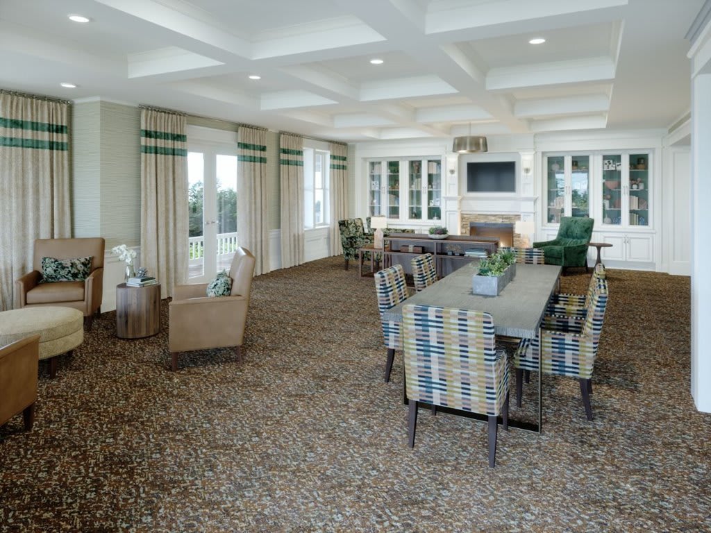 A modern living room with a dining area, featuring comfortable seating, patterned chairs, and a coffered ceiling.