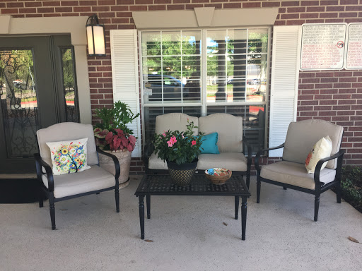A cozy outdoor seating area with comfortable chairs and decorative touches.