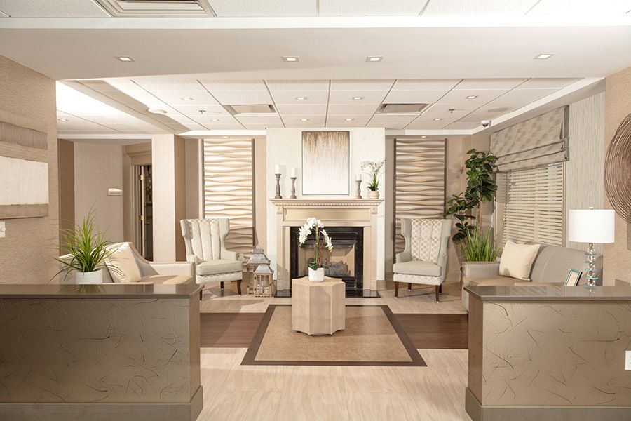 A modern and elegant lobby with comfortable seating and a fireplace.