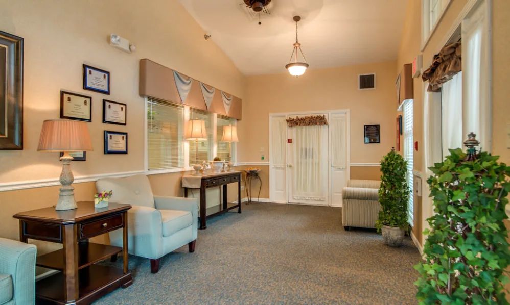 A cozy waiting room with comfortable seating, warm lighting, and decorative elements.