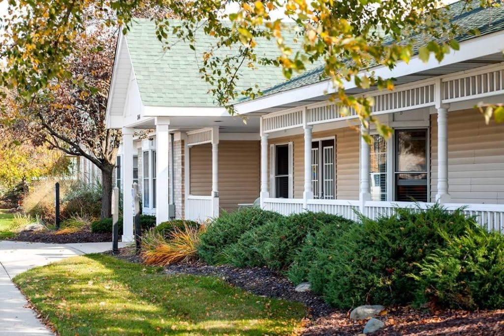 A cozy residential house with a front porch and landscaped yard.