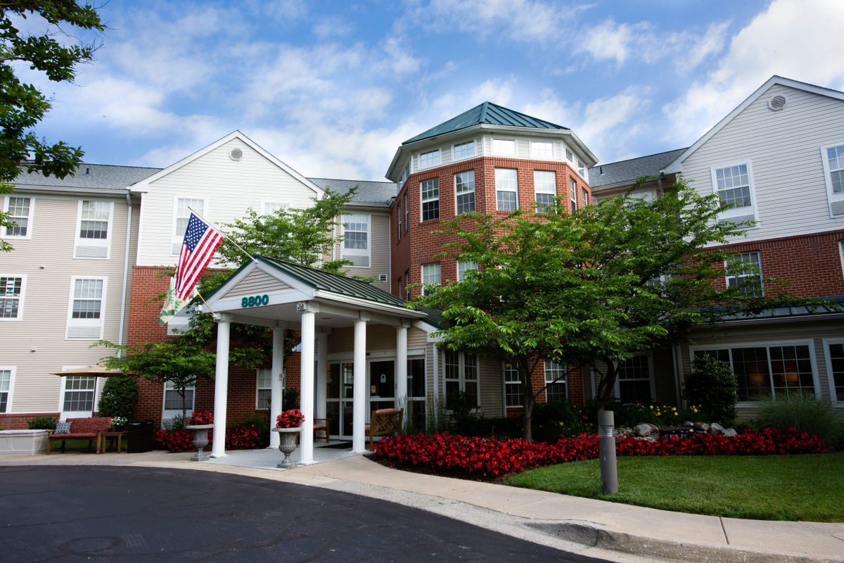 A residential building with a prominent entrance and landscaped surroundings.