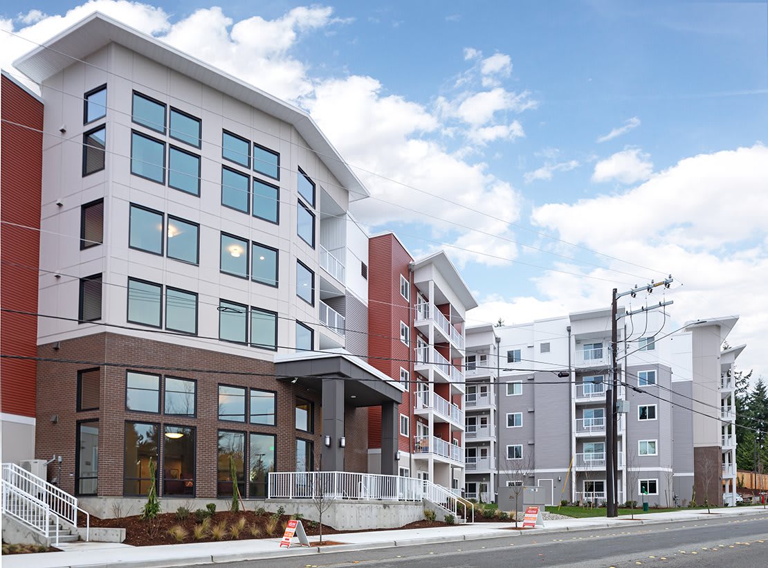 Modern apartment building with multiple stories and a contemporary design.