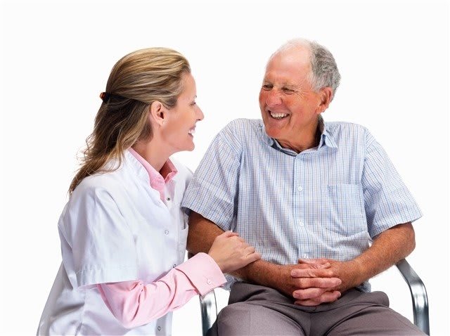 A doctor conversing with an elderly patient, showcasing a friendly and caring interaction in a healthcare setting.