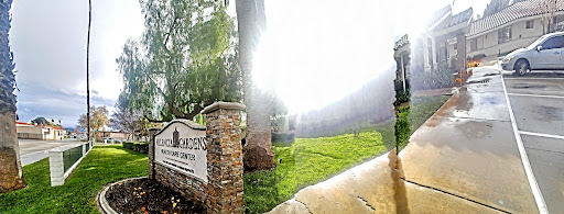A picturesque view of a welcoming entrance, surrounded by lush greenery and bright sunlight.