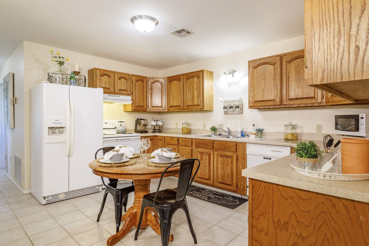 A cozy kitchen with wooden cabinets and a small dining area.