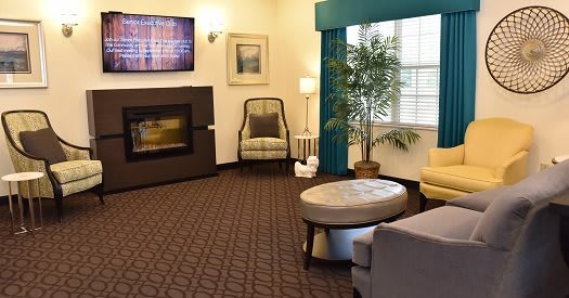 A cozy living room with a modern fireplace and comfortable seating.