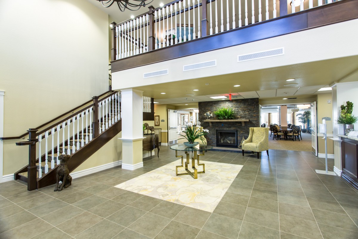 A spacious and modern lobby with elegant decor and a staircase.