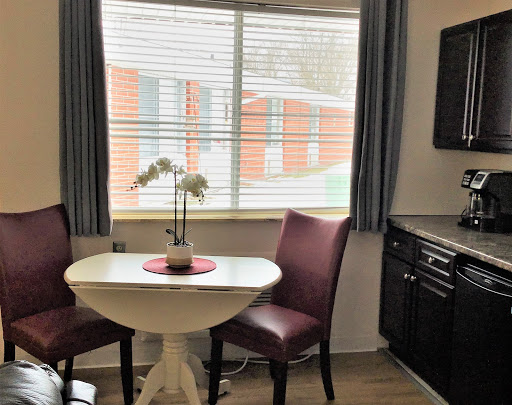 A cozy dining nook with a small table and chairs, featuring a lovely window view.