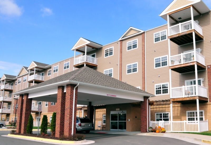 A multi-story residential building with an entrance awning and balconies.